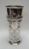 A VICTORIAN SILVER TAPERED VASE of circular-footed form, relief-decorated and with centre