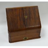 A MAHOGANY SLOPED STATIONERY CABINET with stepped interior and base drawers