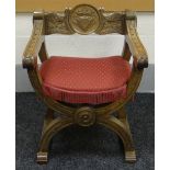 A CARVED OAK HERALDIC X-CHAIR with medallion back bearing shield and crown and with carved rosettes