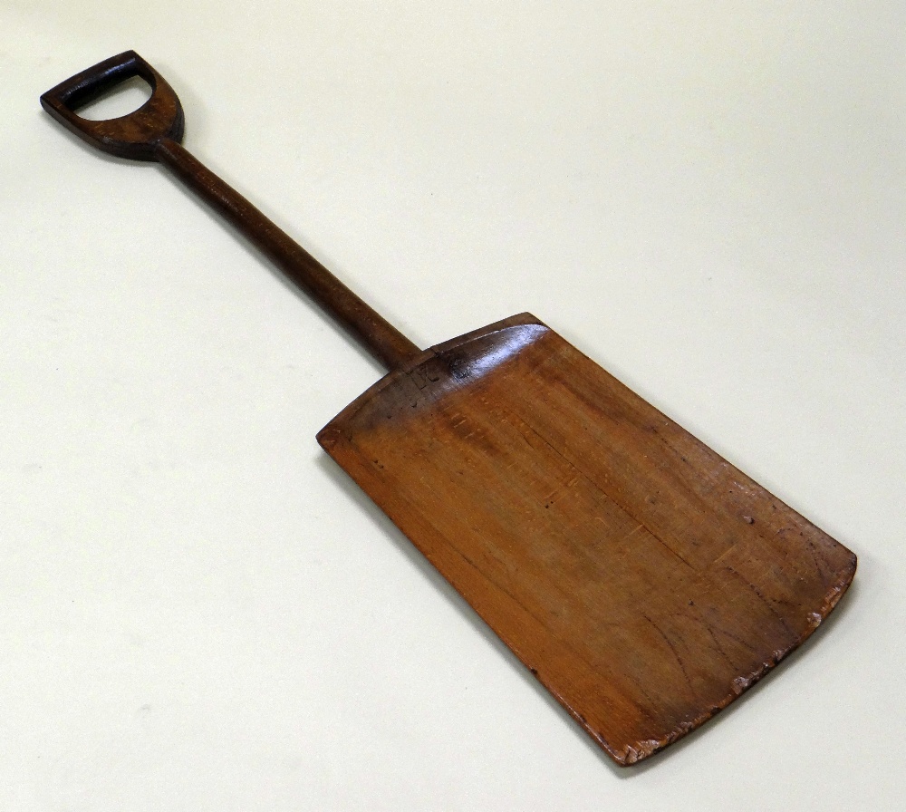 AN ONE-PIECE WOODEN PEAT SHOVEL, 105cms long