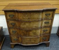 A VINTAGE-REPRODUCTION CHEST OF DRAWERS composed of four long graduated drawers with shaped facade