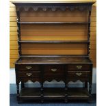 A NINETEENTH CENTURY WEST WALES OAK DRESSER having a base of two flanking drawers to a single centre