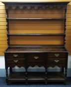 A NINETEENTH CENTURY WEST WALES OAK DRESSER having a base of two flanking drawers to a single centre