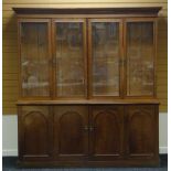 AN OAK AND PINE BOOKCASE CUPBOARD the base with two doors to the wider cupboard and having a top