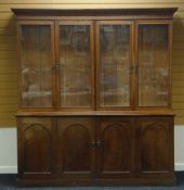 AN OAK AND PINE BOOKCASE CUPBOARD the base with two doors to the wider cupboard and having a top