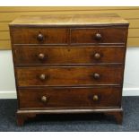 A NINETEENTH CENTURY OAK CHEST of three graduated and two short drawers with turned knobs and on