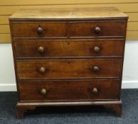 A NINETEENTH CENTURY OAK CHEST of three graduated and two short drawers with turned knobs and on