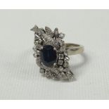 A DIAMOND & SAPPHIRE CLUSTER RING of abstract form with centre sapphire and approximately 40