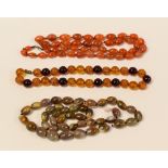 THREE STRANDS OF BEADS including agate and believed red amber