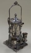 AN AMERICAN QUADRUPLE SILVERPLATE REFRESHMENT SET comprising a large jug pivoting on a figural