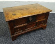 AN EIGHTEENTH CENTURY WELSH OAK COFFER-BACH of moulded panelled form with hinging lid above a single