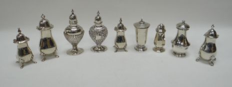 NINE SILVER PEPPERETTES of 'small' size and including a trio, 10ozs total