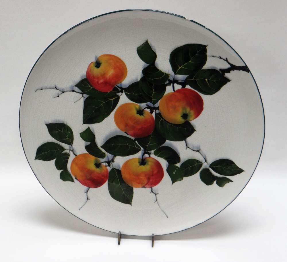A GEORGE STEWART OF BRISTOL POTTERY TRAY of circular form, painted with apples and their branches