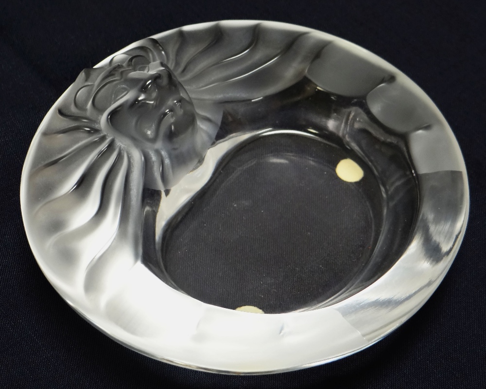 A LALIQUE GLASS CIGAR ASHTRAY with lion head to the border, signed 'Lalique France', 15cms diam
