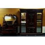 AN EDWARDIAN MAHOGANY PART BEDROOM SUITE comprising ornate carved triple wardrobe, 181cms wid