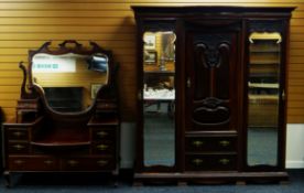 AN EDWARDIAN MAHOGANY PART BEDROOM SUITE comprising ornate carved triple wardrobe, 181cms wid