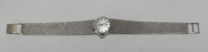 A BOXED TISSOT 9CT WHITE-GOLD LADIES WATCH having a circular silver dial, 26gms