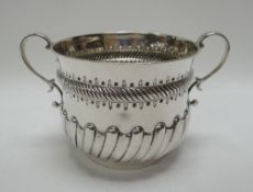 A SILVER PORRINGER with relief decoration and inscribed 'Joan', Sheffield 1905, 6.8ozs