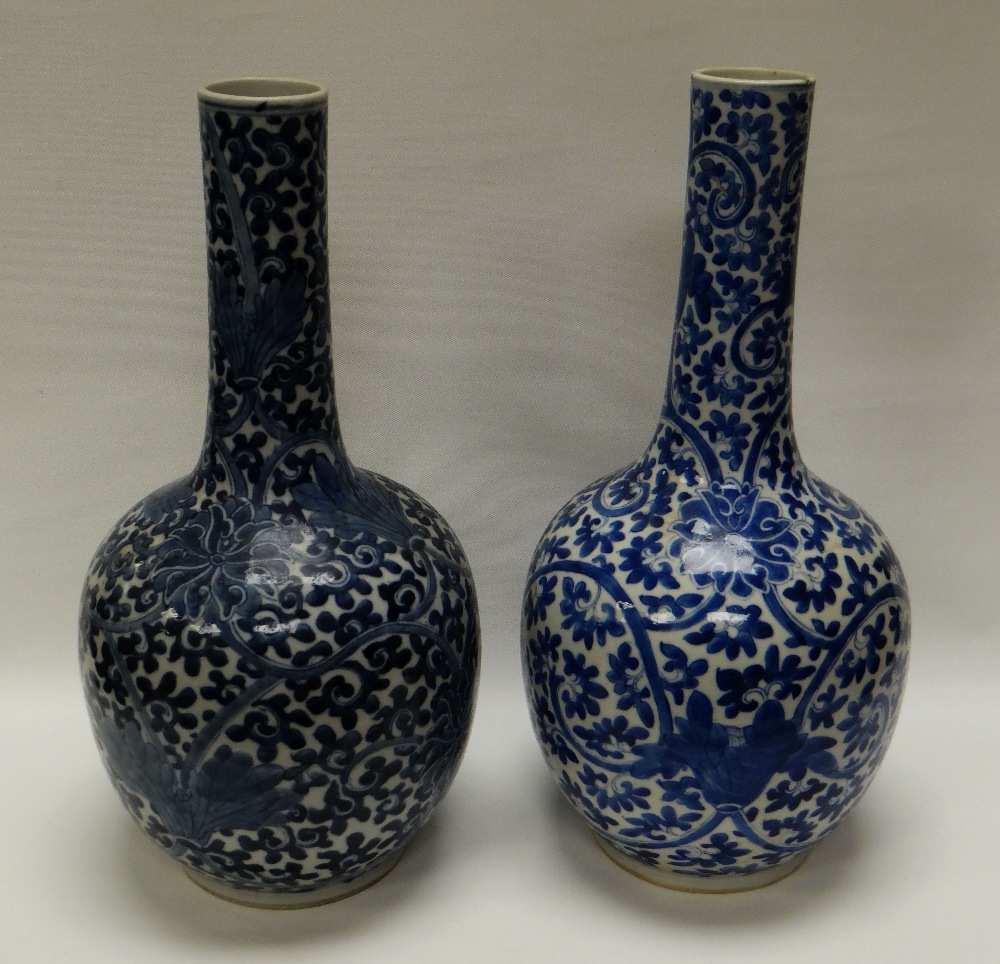 A PAIR OF CHINESE BLUE & WHITE BOTTLE VASES, with stylised chrysanthemum and foliate decoration in