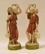 A PAIR OF ROYAL DUX FIGURE WATER CARRIERS on circular naturalistic bases, 25 cms high