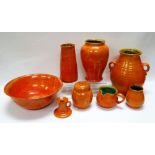 A WILLIAM FISHLEY HOLLAND STUDIO POTTERY SUITE OF EIGHT in tangerine mottled glaze and including a