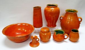 A WILLIAM FISHLEY HOLLAND STUDIO POTTERY SUITE OF EIGHT in tangerine mottled glaze and including a