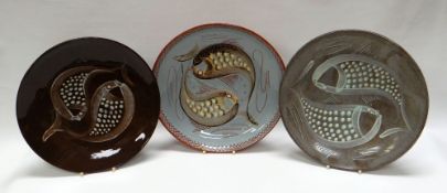 A WILLIAM FISHLEY HOLLAND STUDIO POTTERY TRIO of circular dishes sgraffito and relief decorated with