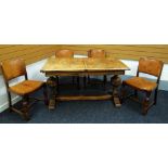 A MID-TWENTIETH CENTURY OAK TRESTLE DINING TABLE and four good tan leather studded dining chairs