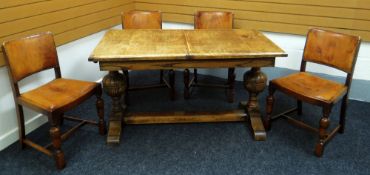 A MID-TWENTIETH CENTURY OAK TRESTLE DINING TABLE and four good tan leather studded dining chairs