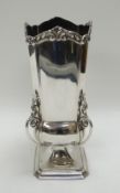 A SQUARE-BASED SILVER VASE having four fancy handles and feathered border, Sheffield 1903, 11.3ozs