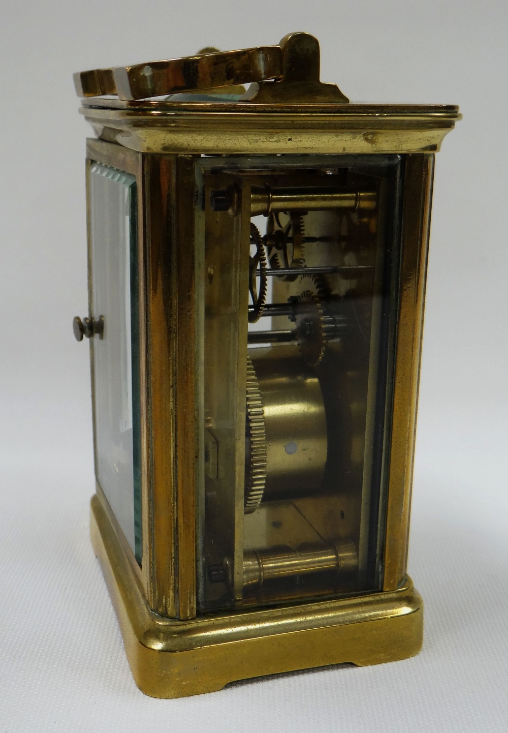 A BEVELLED GLASS CARRIAGE CLOCK bearing Roman numerals to the rectangular white dial (key with - Image 2 of 2