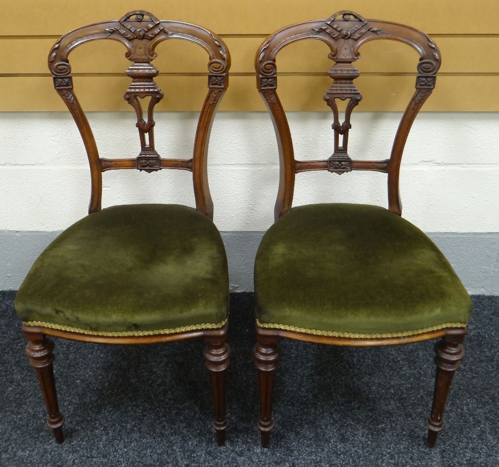 A PAIR OF MAHOGANY HALL CHAIRS having green upholstered stuff-over seats, tapered and fluted legs