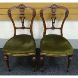 A PAIR OF MAHOGANY HALL CHAIRS having green upholstered stuff-over seats, tapered and fluted legs