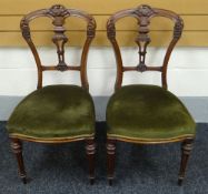 A PAIR OF MAHOGANY HALL CHAIRS having green upholstered stuff-over seats, tapered and fluted legs