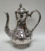 A BRITANNIA METAL COFFEE POT with all-round relief decoration of flowers and scrolls, with eagle-