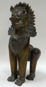 A CHINESE BRONZE STANDING DOG OF FO CREATURE 28cms high