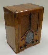 A FERGUSON FOUR BAND CABINET RADIO in an Art Deco polished case, 51cms high