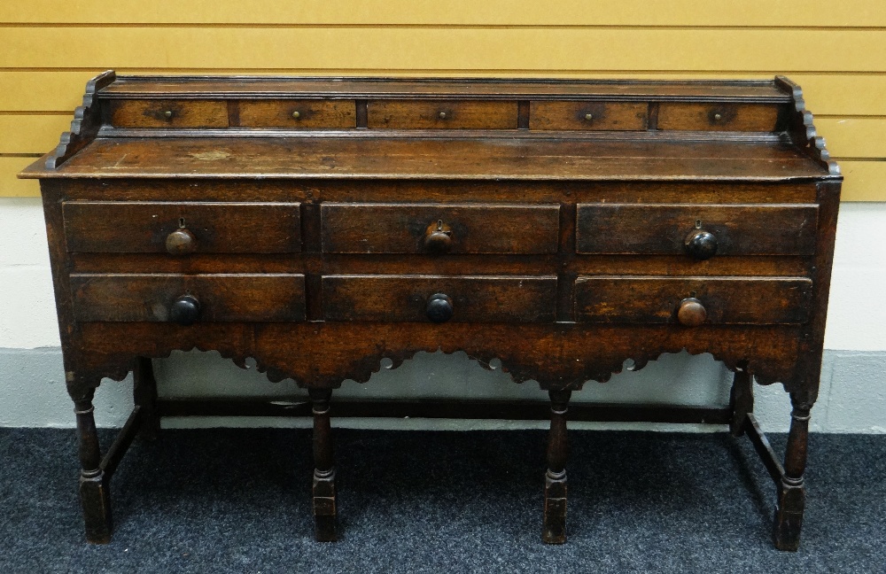 AN EARLY NINETEENTH CENTURY WELSH OAK DRESSER, the base with an arrangement of six drawers and