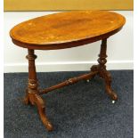 AN INLAID WALNUT OVAL OCCASIONAL TABLE on turned supports and carved scroll feet, 90cms long