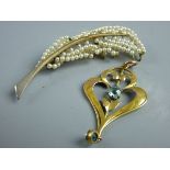 A NINE CARAT GOLD PENDANT heart shaped with two blue? stones, 2 grms, a leaf brooch encrusted with