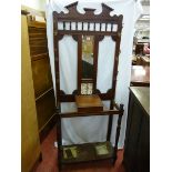 AN EDWARDIAN MAHOGANY HALL STAND with narrow mirror and tile back to a hinged glove box with