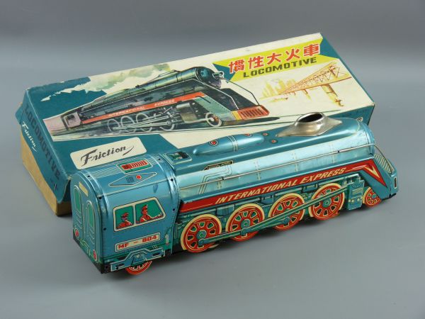 A TINPLATE FRICTION DRIVE LOCOMOTIVE, FM-804 International Express in brightly coloured livery,