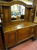 A 1930's OAK MIRROR BACK SIDEBOARD with carved decoration, bulbous shelf and lower supports, 176 x