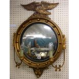 A CONVEX WALL MIRROR, gilt framed with ball decorated frame, eagle atop and with a pair of side