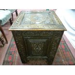 A CARVED OAK LOG BOX, near square with deep Jacobean style decoration and iron carry handles on