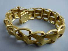 AN EIGHTEEN CARAT GOLD BANGLE, wide linked, matt gold, 60 grms