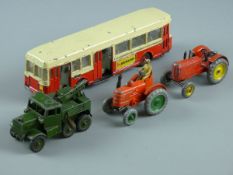 FOUR VINTAGE DINKY TOY VEHICLES to include a French made autobus 'Berliet', a recovery tractor in