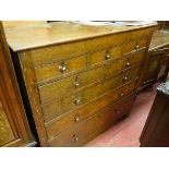 A CIRCA 1800 OAK CHEST of eight drawers in a mixed arrangement of three over two over three, with