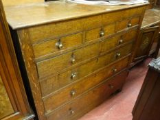 A CIRCA 1800 OAK CHEST of eight drawers in a mixed arrangement of three over two over three, with