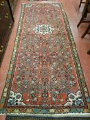 A PERSIAN HAMADAN RUNNER, red ground, 275 x 110 cms approximately